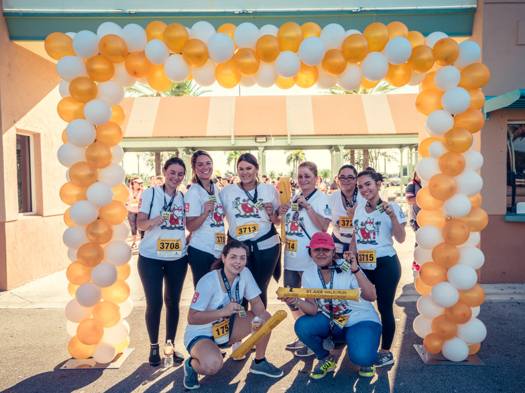 Some Petland team members pose together in front of St. Jude Walk balloon entrance.
