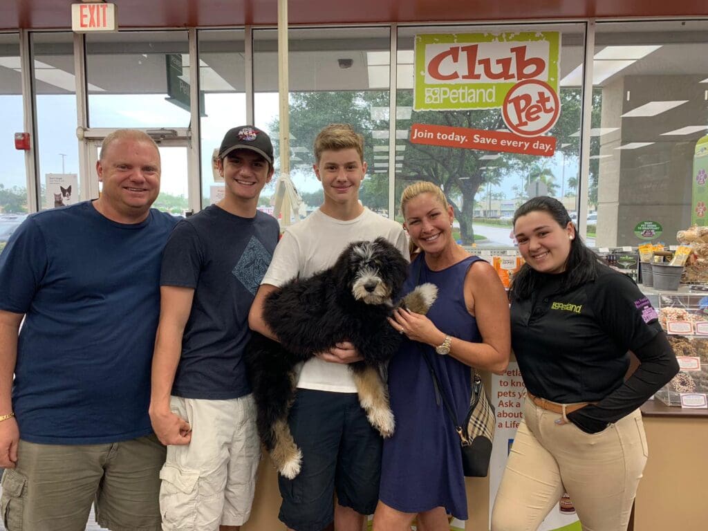 Petland Texas picture of family of Marjory Stoneman Douglas High School survivor holding their cute Petland puppy.