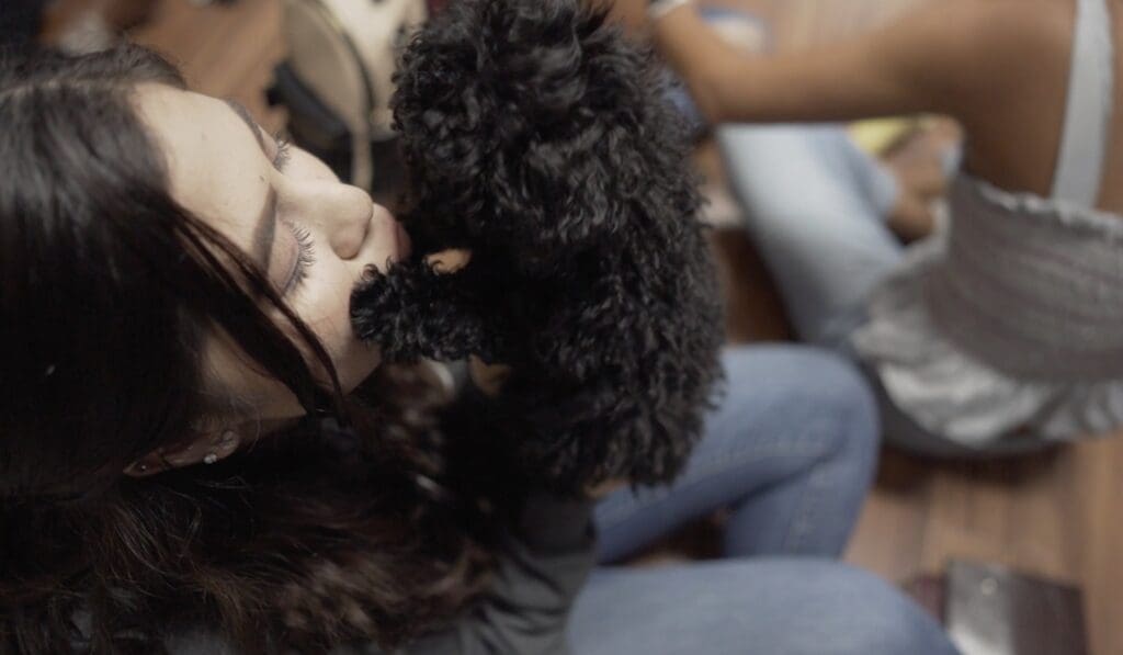 Petland Texas picture of Refuge Student Ministry student holding a cute Petland puppy.