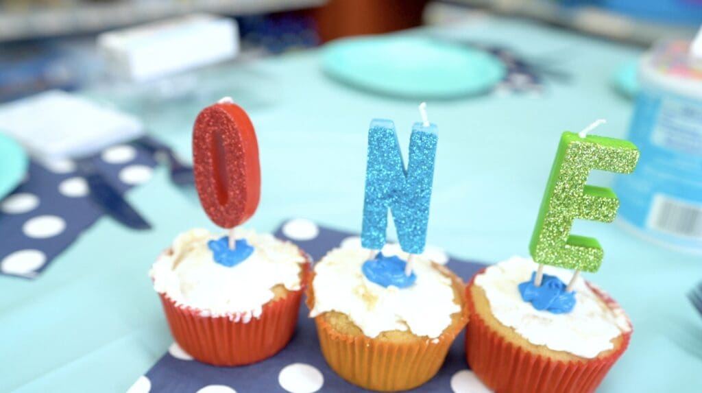 Petland Texas picture of yummy doggy cupcakes with candles that say "one" for puppy's first birthday.