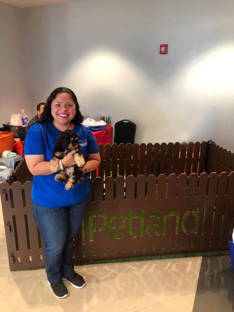 Petland Texas picture of Veterans Outreach Day participant holding a cute Petland puppy.