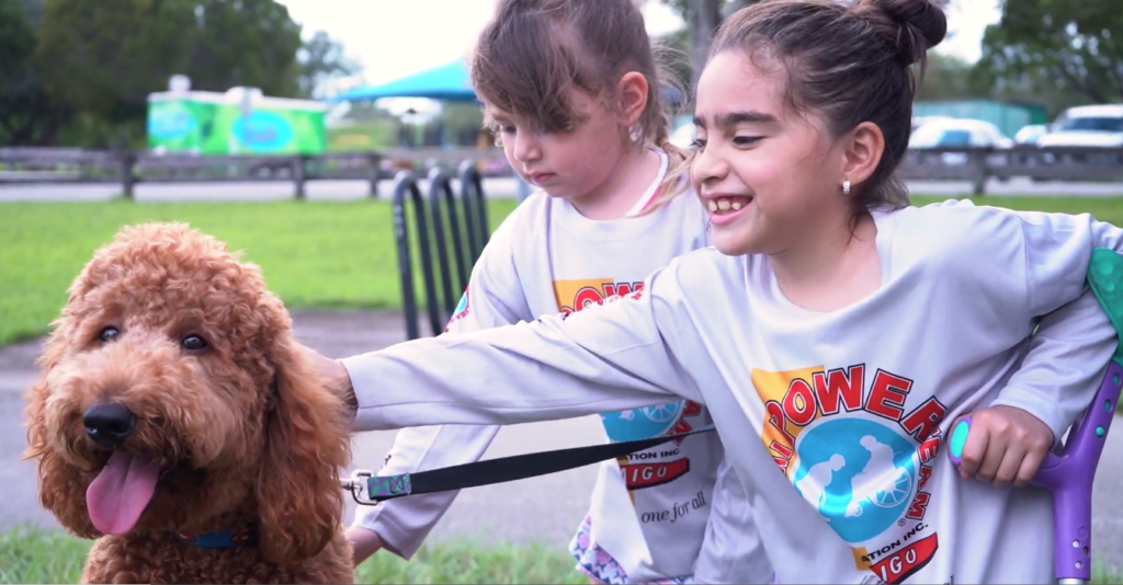 Petland Texas picture of Goldendoodle puppy, Jax with Miami Power Team children.