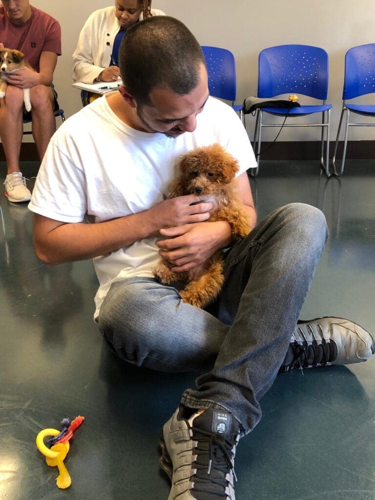 Petland Texas picture of cute Petland puppy with a patient from the Holistic Recovery Center.