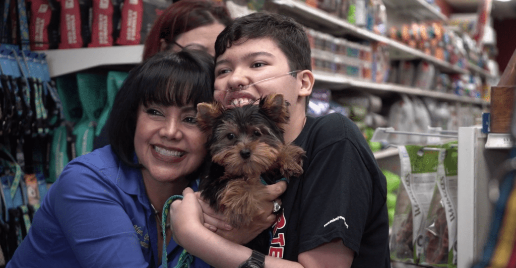 Petland Texas picture of Sebastian holding a cute Yorkie puppy from Petland Kendall.