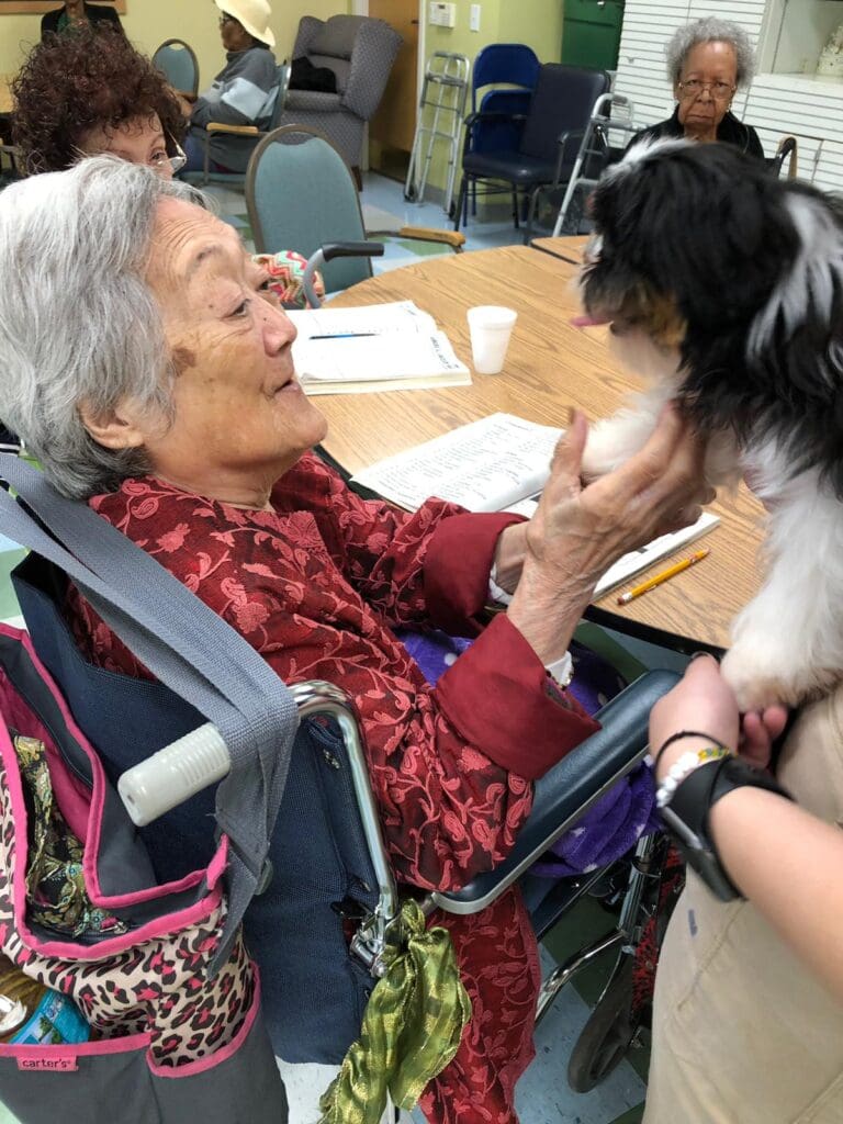 Petland Texas picture of patient holding puppy at Southwest Focal Point Senior Center.