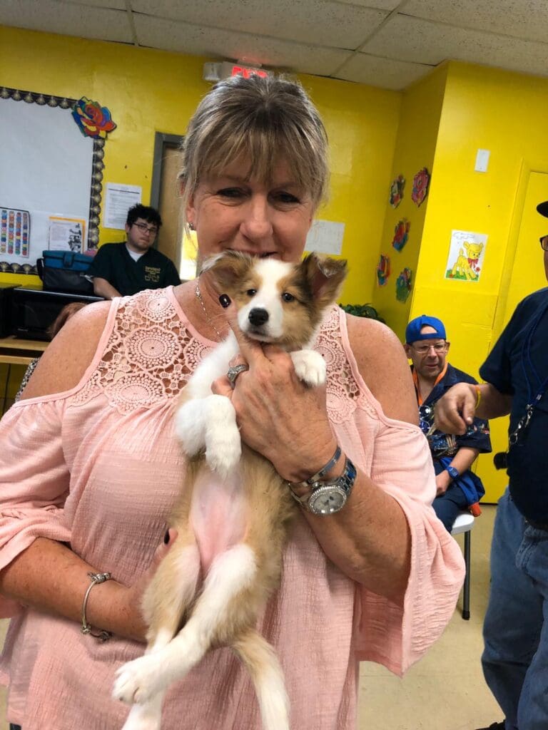 Petland Texas picture of a patient from Lucanus Center holding a cute Petland puppy.