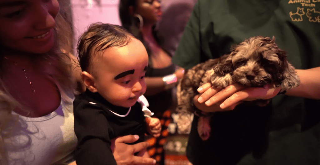 Petland Texas picture of baby with cute Petland puppy at Boo-ville event.