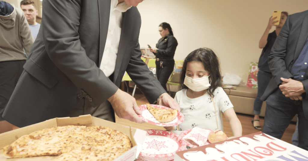 Petland Texas picture of a young patient from Holtz Children's Hospital getting pizza.