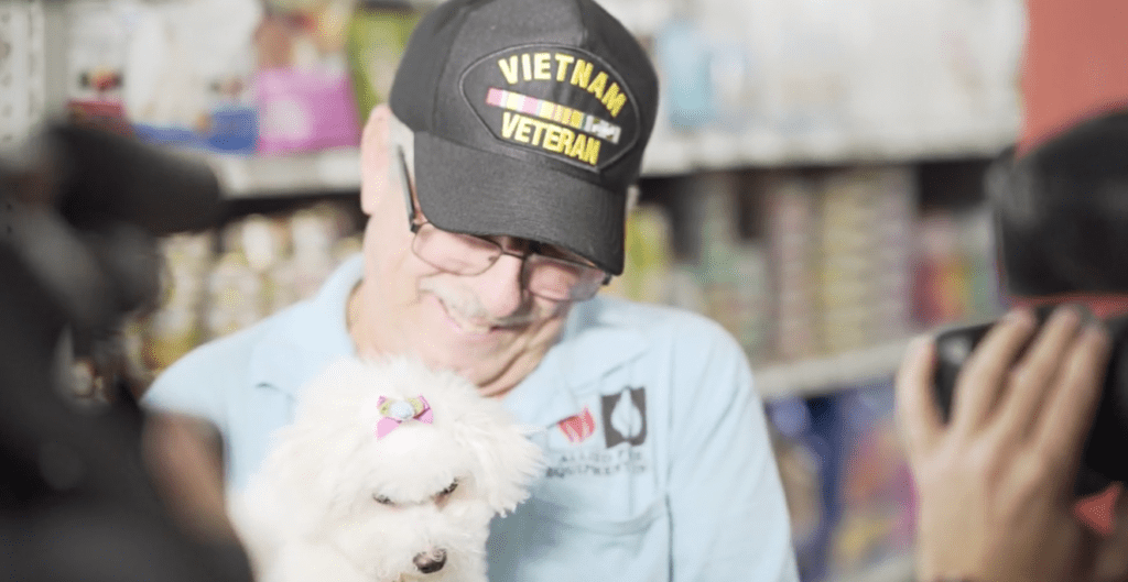 Petland Texas picture of Vietnam veteran holding new Bichon Frise puppy.