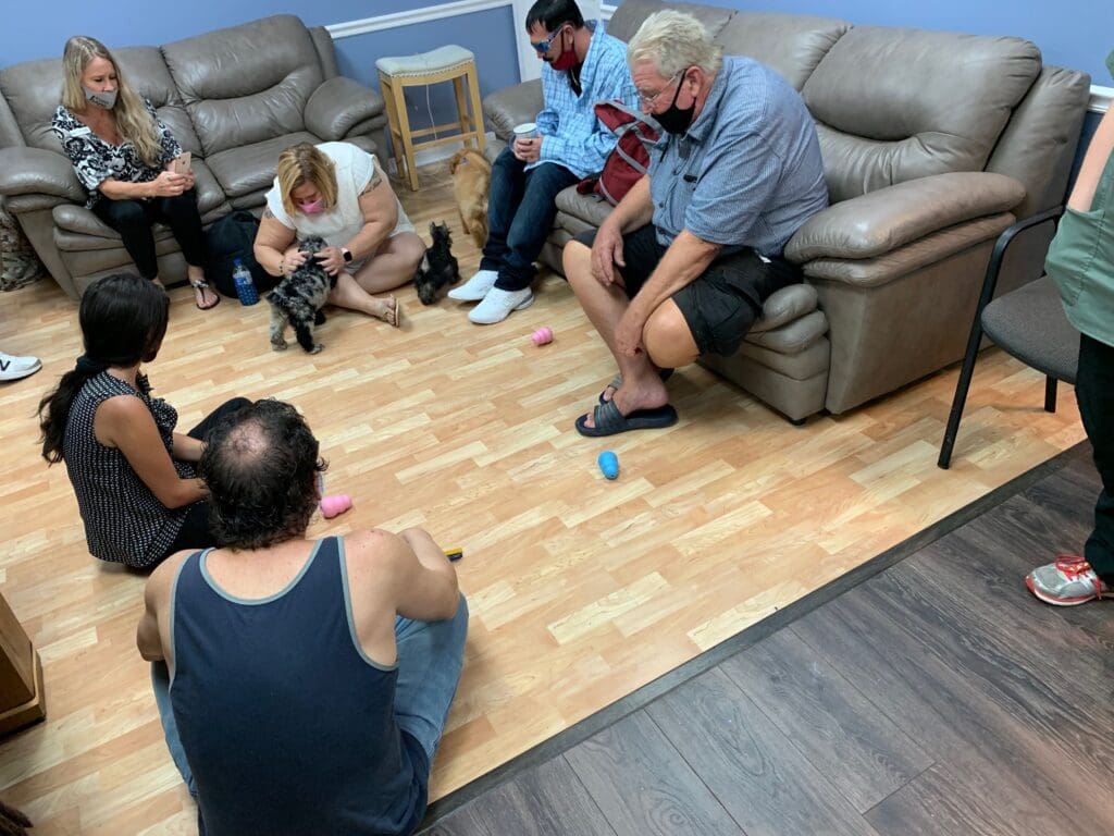 Petland Texas picture of NAMI rehab center patients playing with cute Petland puppies for puppy therapy.