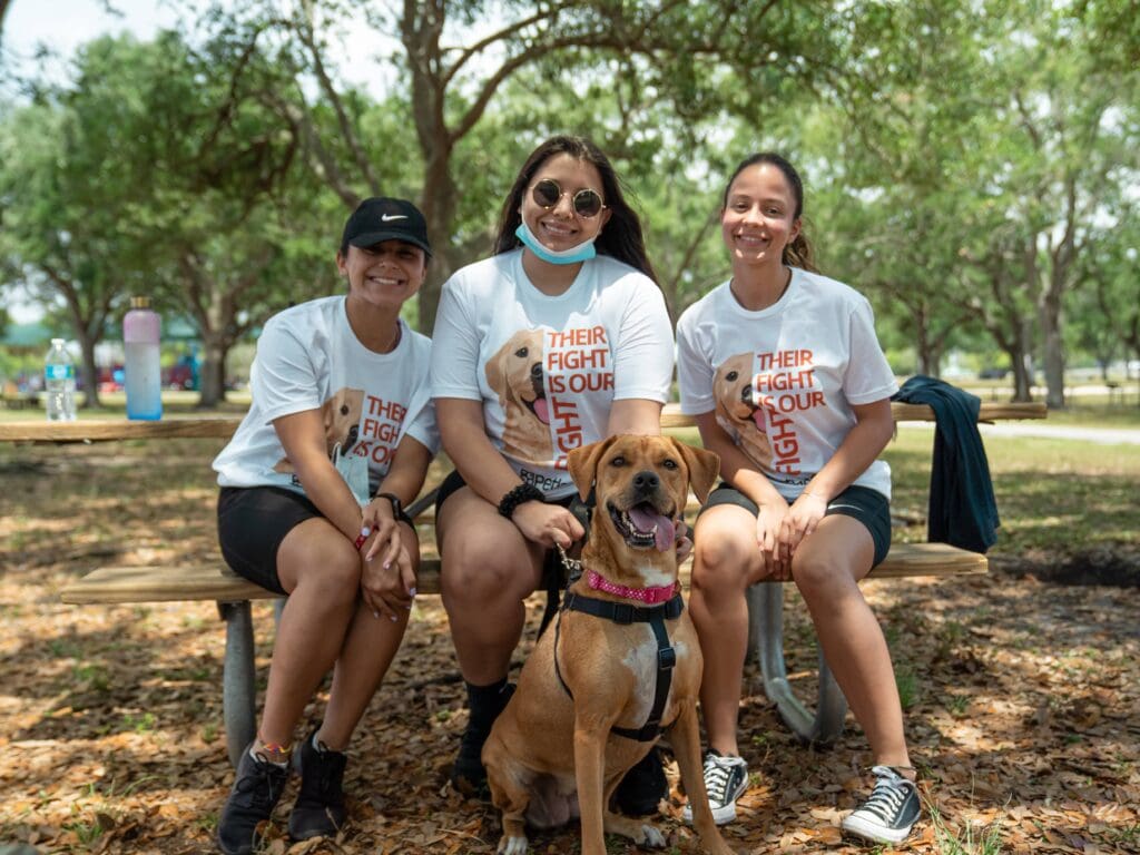 community members and volunteers from Petland Texas gathered together with a dog for March for Cancer event.